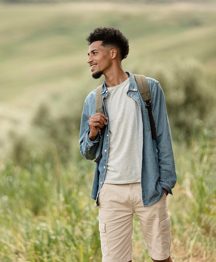 Young man hiking outdoors with a backpack, representing freedom, self-discovery, and personal growth
