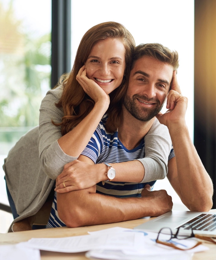 Smiling couple sitting together at home, showing warmth, happiness, and a strong emotional connection